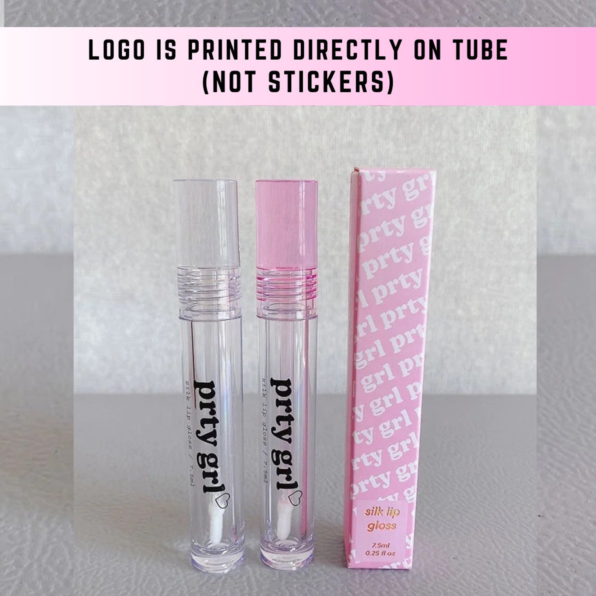 Lip gloss tubes with clear and pink lids, "prty grl" text, and pink packaging box