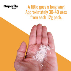 Soap powder on hand, off-white powder, skin tone, Superfly Soap branding visible