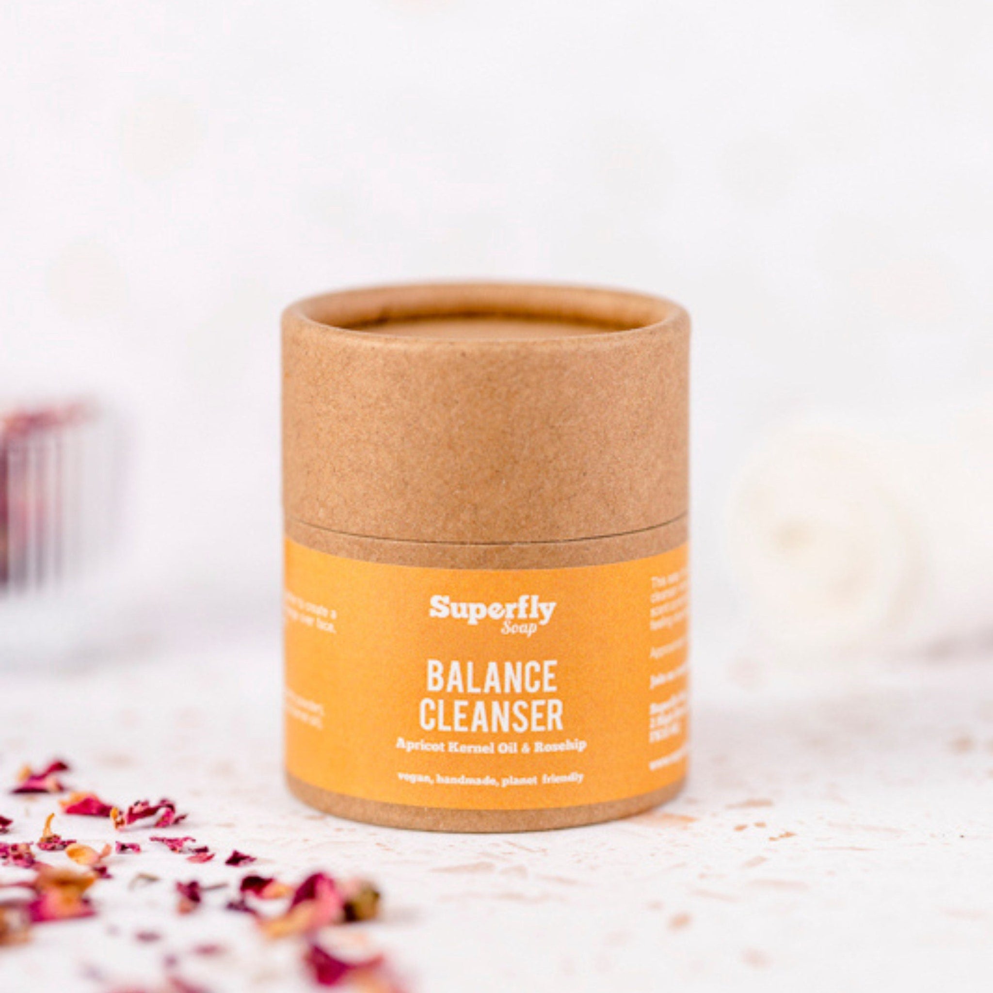 Cleanser in round cardboard tube with orange label, Superfly Soap Balance Cleanser product