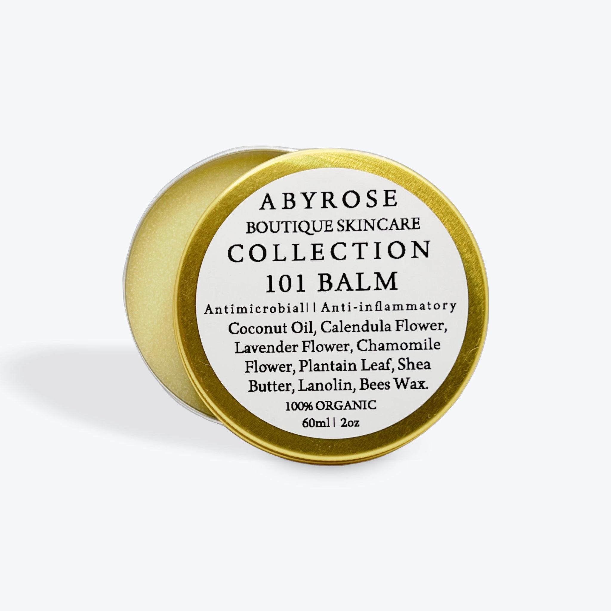 Lip balm tin, gold metal, white label with Abyrose text, product details