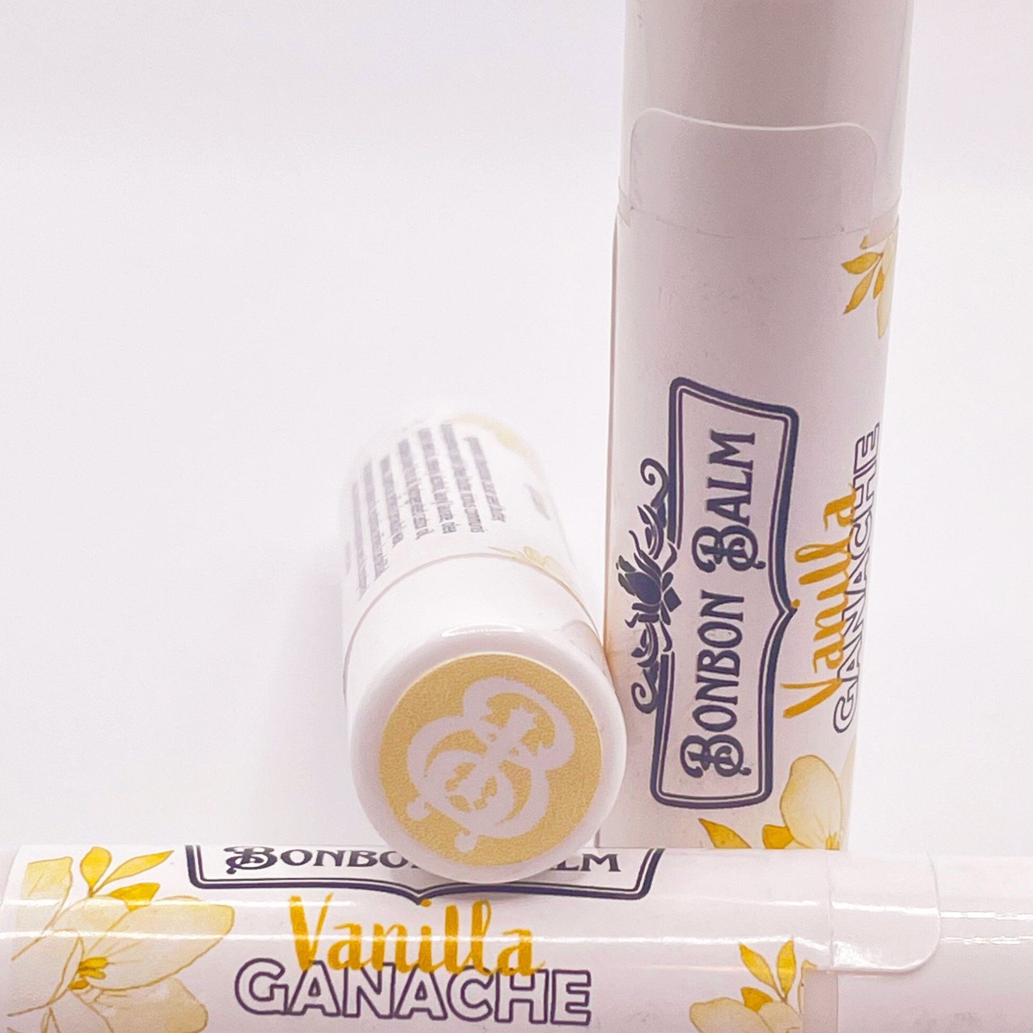 Vanilla lip balm tubes, white with floral design and Bonbon Balm branding
