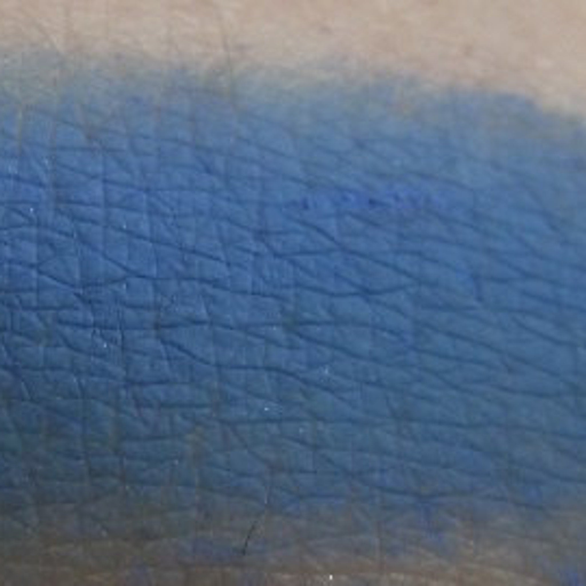 Side view of Pop Blue Sapphire matte eyeshadow pan showing rich pigment depth and smooth texture