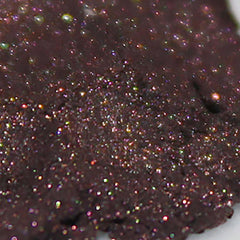Side view of dark rose brown loose powder eyeshadow with shimmer particles in a compact jar