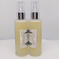 Facial spray bottles with clear plastic tops, silver accents, and Ageless Botanicals label