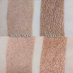 Hand applying metallic rose brown loose powder eyeshadow with a brush for a shimmery eyelid look