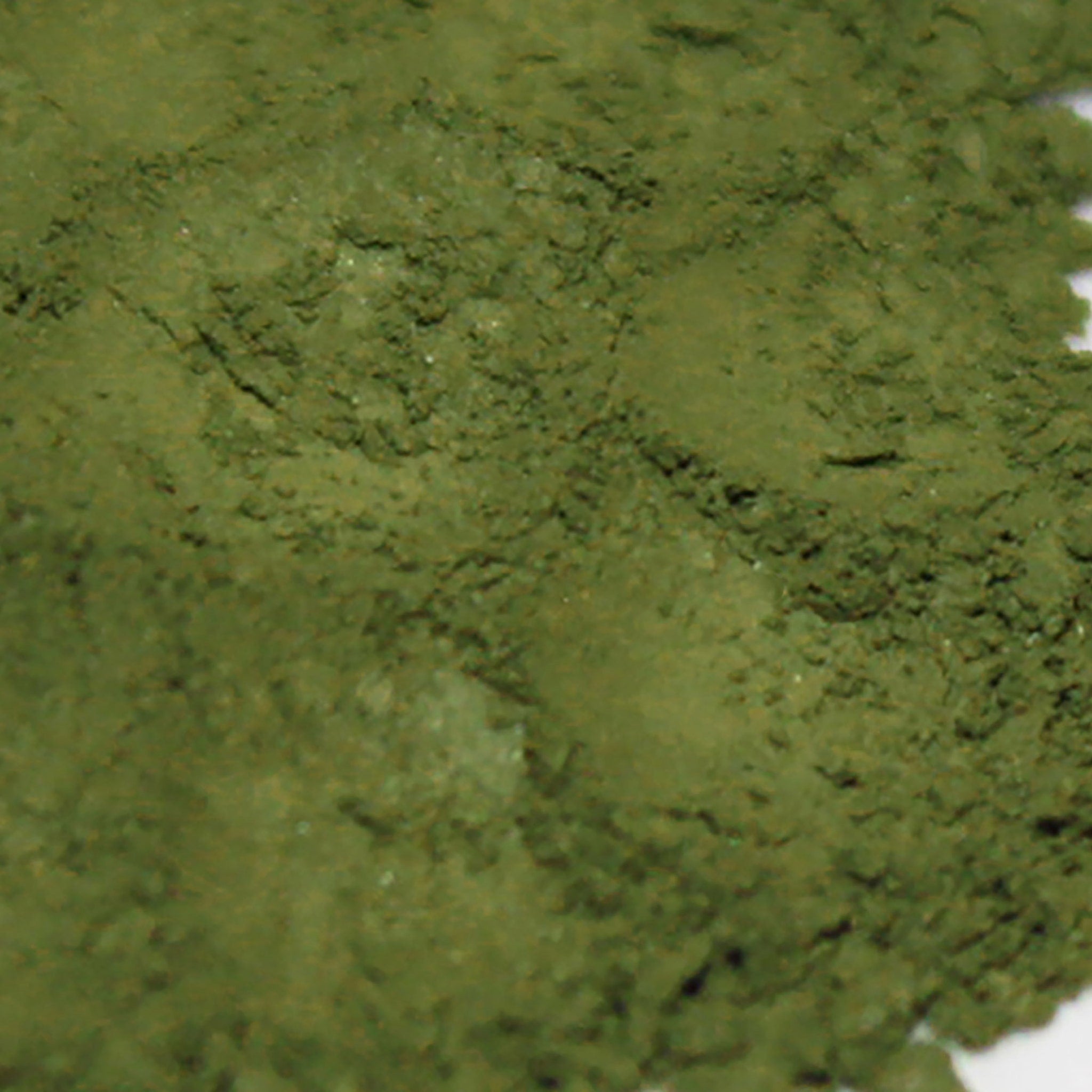 Green powder with textured surface and light color variations, close-up view