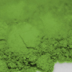 Side view of matte bright green loose powder eye shadow in open container showing pigmented texture