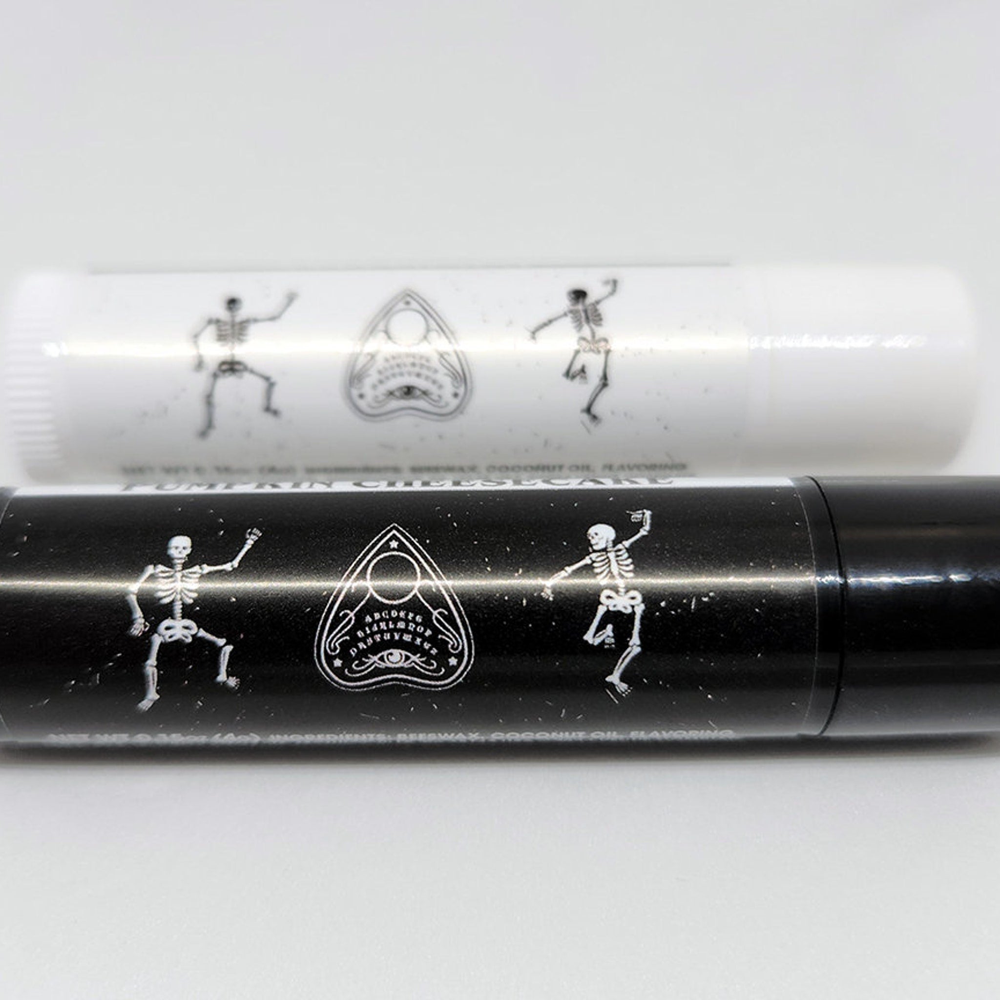 Lip balm tubes, black and white with skeleton and planchette designs, for lip care
