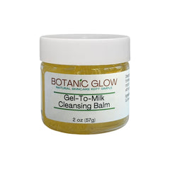 Cleansing balm jar with white lid, yellow contents, and Botanic Glow label