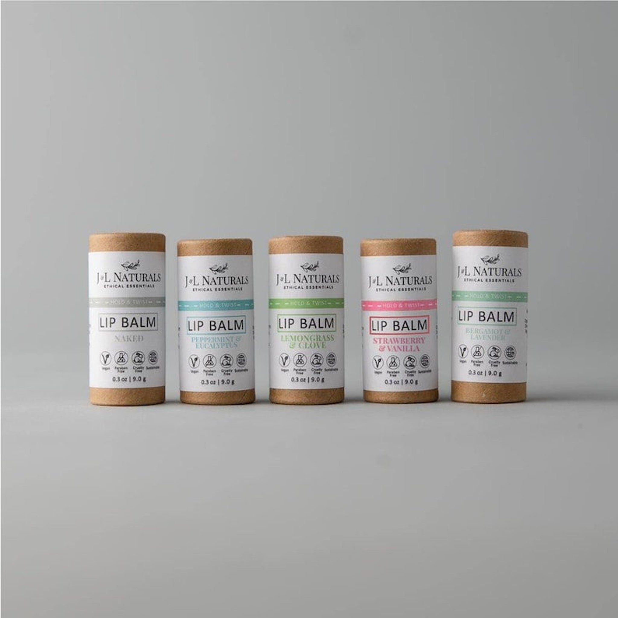 Lip balm tubes in various colors, with J&L Naturals branding and product names, on a neutral background.