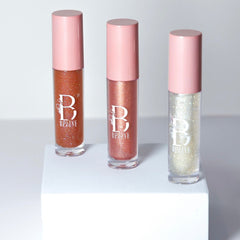 Lip gloss tubes with pink caps, glittery contents, and Bolive Beaute logo visible