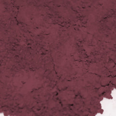 Side view of loose powder eye shadow in rosewood pink and muted fuchsia with matte finish, showing texture and vegan label