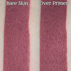 Hand applying rosewood pink loose powder eyeshadow with a brush, creating a soft matte finish on eyelid.