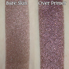 Hand applying dark magenta pink and plum shimmer loose powder eyeshadow with a brush for a goth romantic look