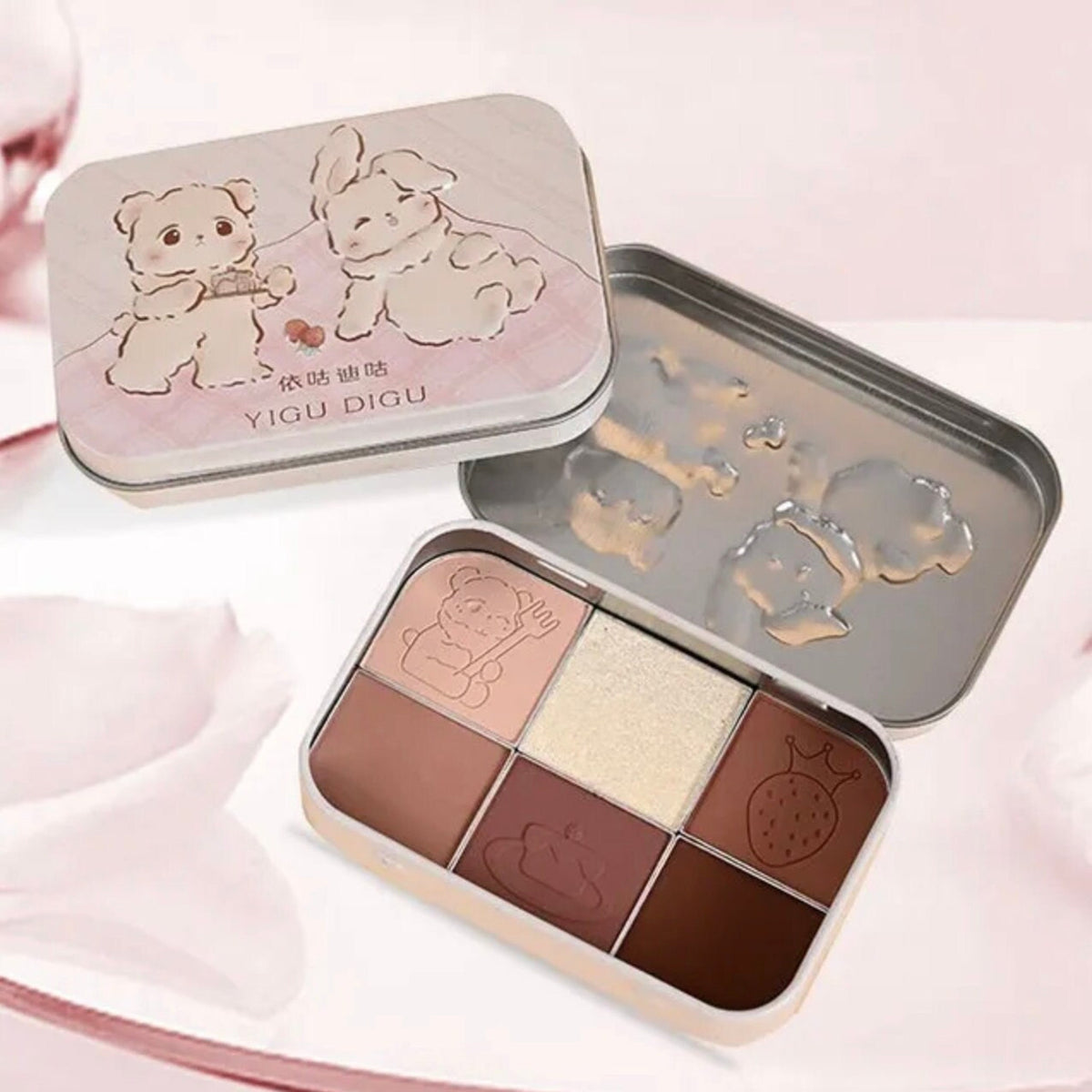 Pastel pink and lavender eyeshadow palette with heart-shaped pans and holographic packaging