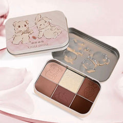 Pastel pink and lavender eyeshadow palette with heart-shaped pans and holographic packaging