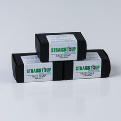 Face soap in black boxes with Straight Up Skin Care branding and white labels