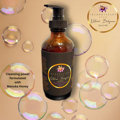Facial cleanser bottle, brown glass, black pump, with Incandescent Lily label and bubbles around