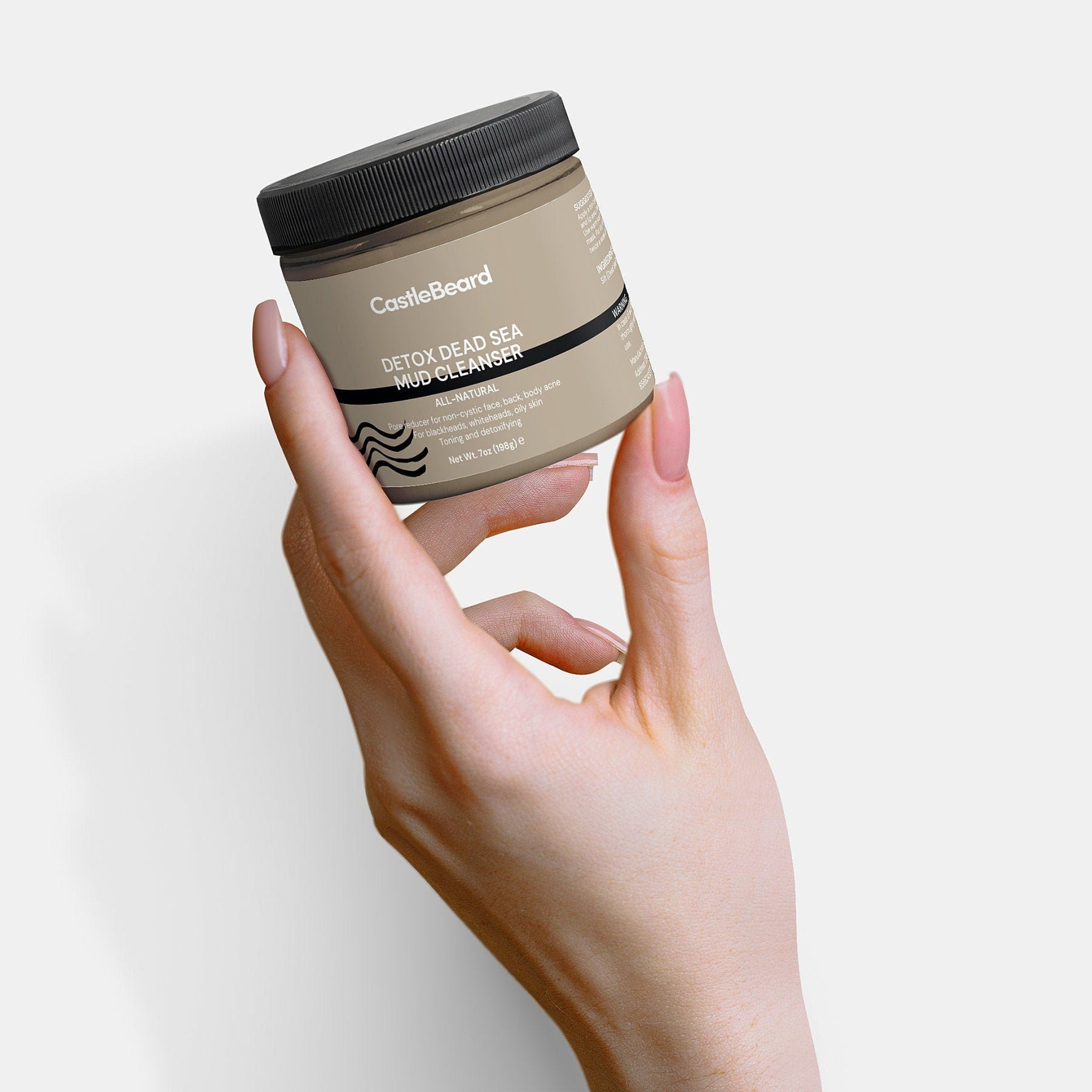 Mud cleanser jar in tan and black, held in hand, with text "CastleBeard" visible