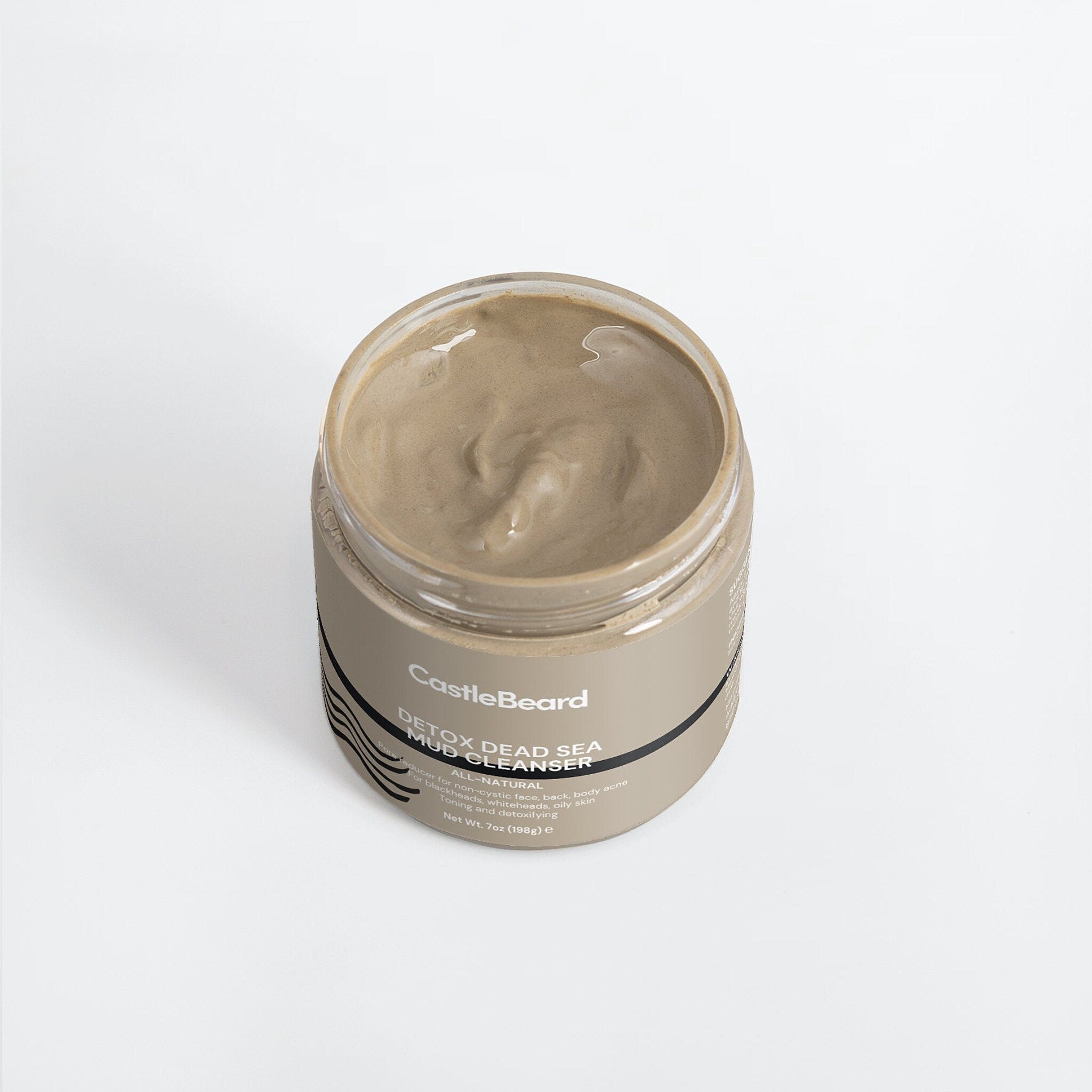 Mud cleanser jar with tan mud, glass jar, and CastleBeard label on a white background