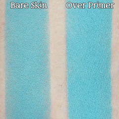 Hand applying light turquoise matte loose powder eyeshadow with brush for soft pastel aqua look