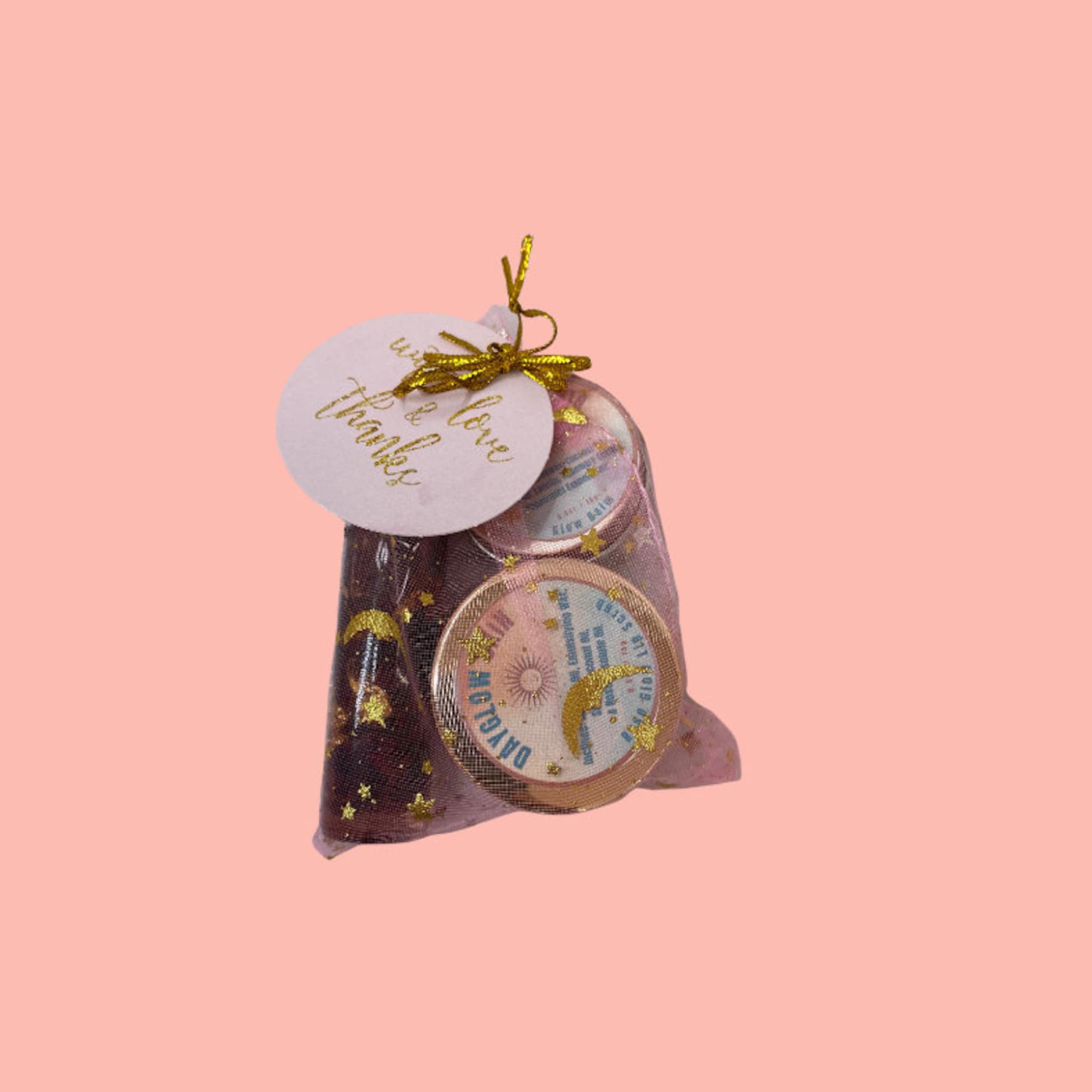 Gift set with gold ribbon, clear mesh bag, and DAYGLOW label with stars and moon pattern