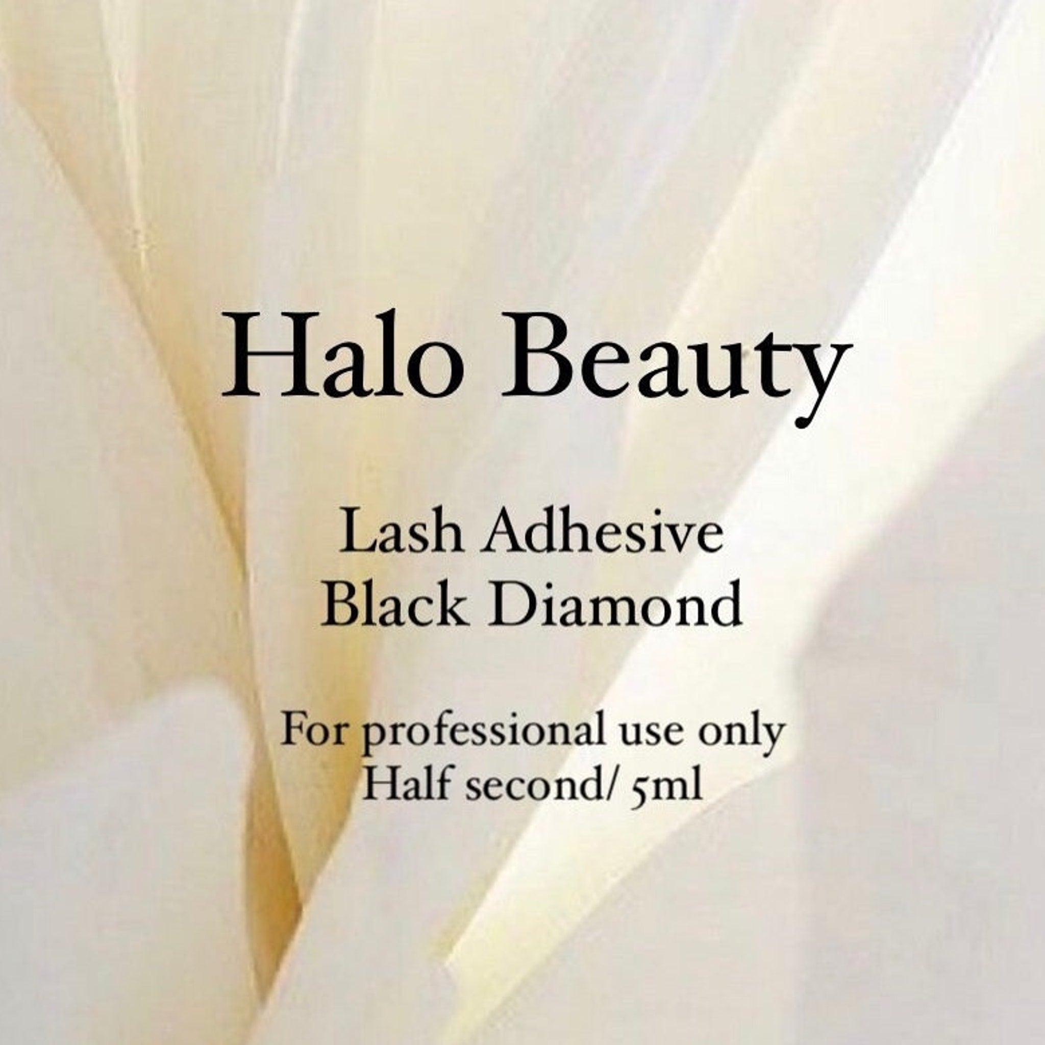 Lash adhesive with Halo Beauty text, white and cream background, black text for professional use only