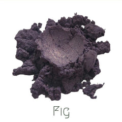 Close-up of deep eggplant purple shimmer eyeshadow with reflective mineral particles in compact pan