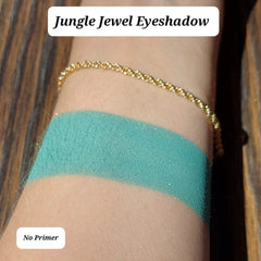 Close-up of vegan green and gold sparkle eyeshadow with shimmering mineral pigments in compact palette