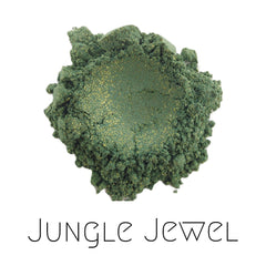 Close-up of vegan green and gold sparkle eyeshadow in Jungle Jewel shade, showcasing shimmering mineral pigments in compact.