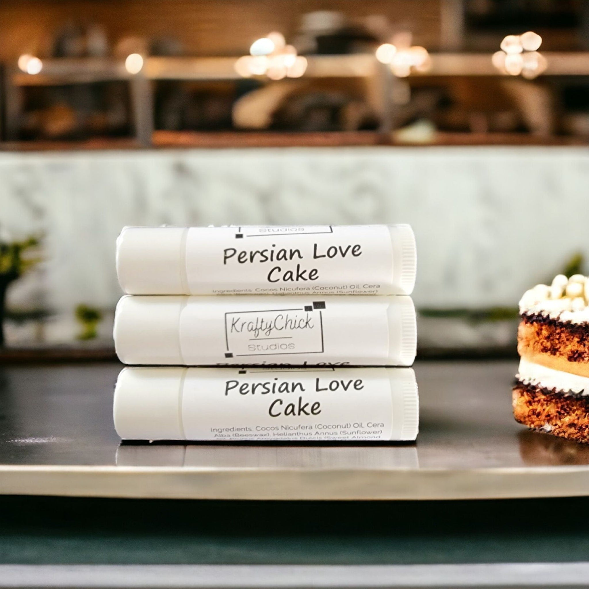 KraftyChickStudios lip balm, white tubes with text, stacked with cake slice