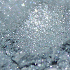 Side view of loose powder eyeshadow in light silver blue with metallic sheen, vegan Camelot Collection