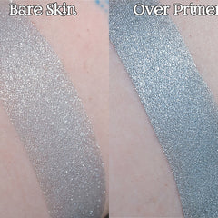 Hand applying shimmering light silver blue loose powder eyeshadow with fingertip for metallic effect