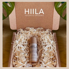 Lip balm tube in cardboard packaging with shredded paper, brand HIILA visible