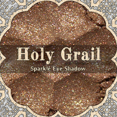 Golden brown loose powder eyeshadow with gold duochrome shimmer and silver glitter flecks in a sifter jar