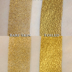 Gold eyeshadow swatch with bare skin and foiled textures, close-up view