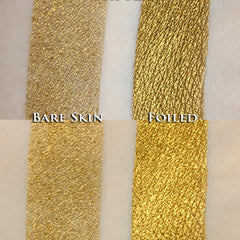 Hand applying metallic olive gold loose powder eyeshadow with a fluffy brush for a shimmery steampunk look