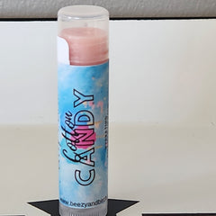 Lip balm with pink balm, blue patterned label, and BEEzy & Birch branding