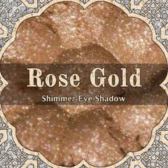 Rose gold loose powder eyeshadow with shimmering light pink and peach gold tones in a small jar