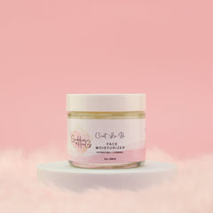 Face moisturizer jar with white lid, glass jar, and pink label on white pedestal