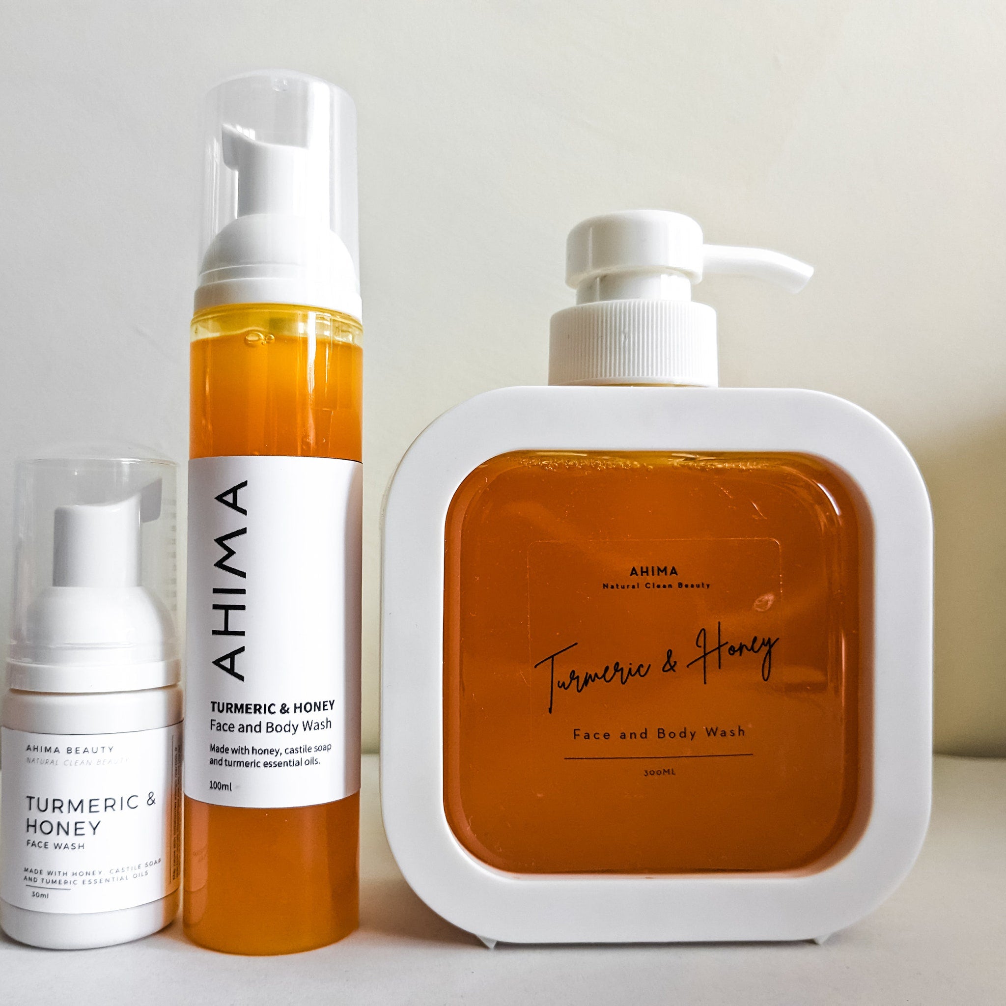 Face and body wash bottles, white and orange, AHIMA brand, for cleansing