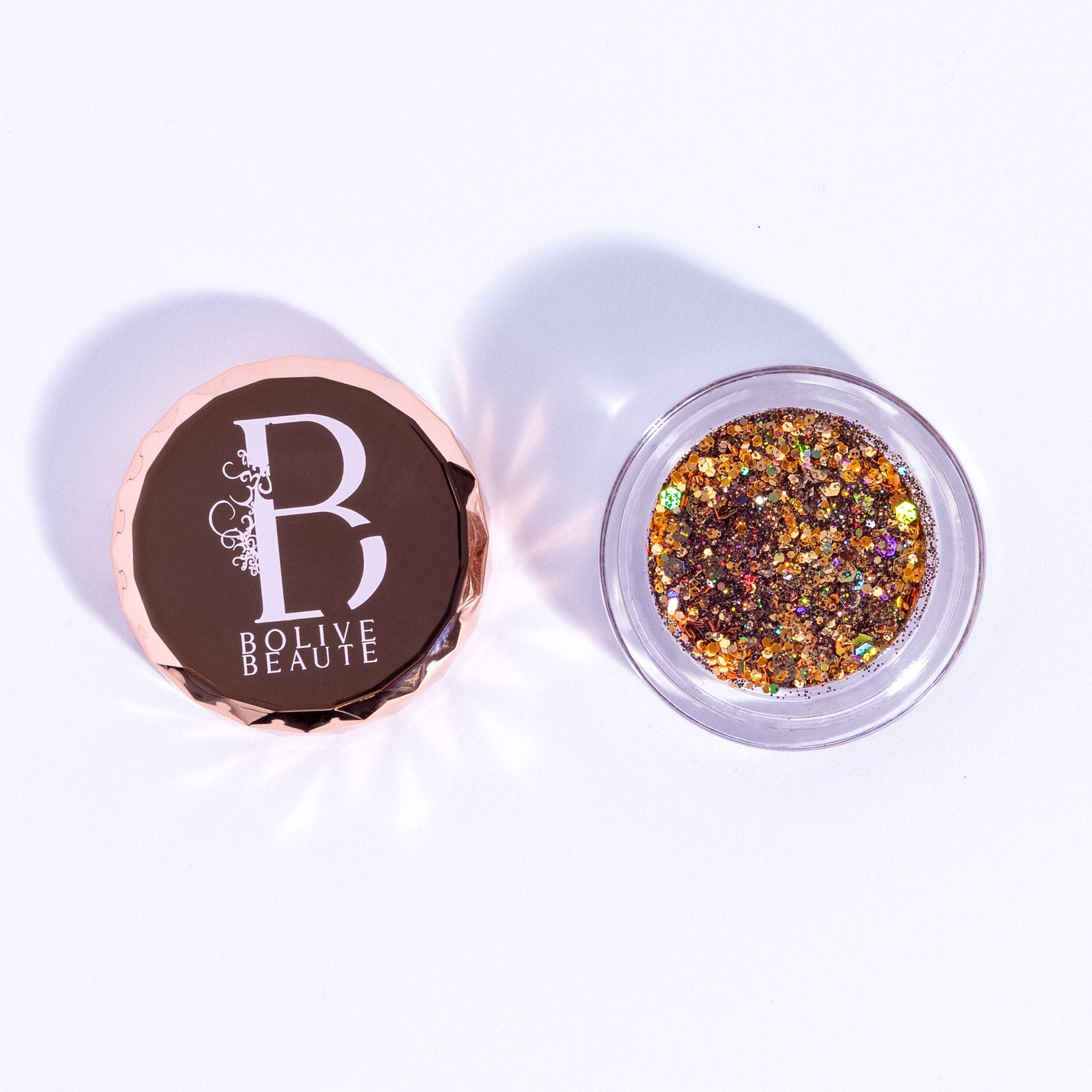 Close-up of warm brown sugar glitter eyeshadow palette with sparkling gold reflect particles