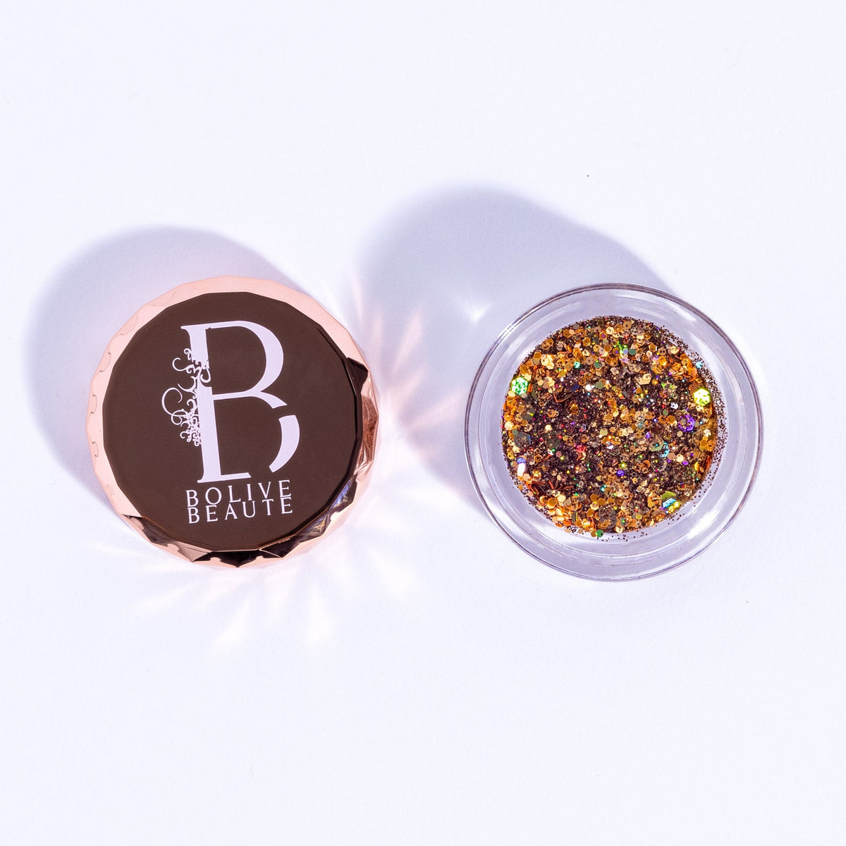 Close-up of warm brown sugar glitter eyeshadow palette with sparkling gold reflect particles