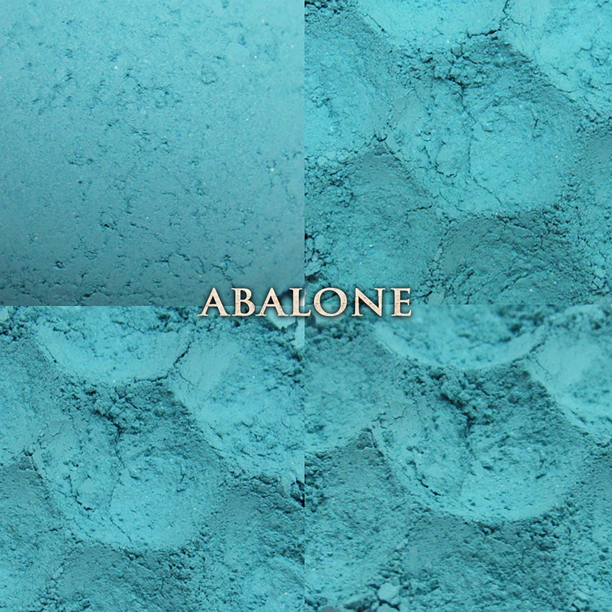 Side view of pastel aqua vegan loose powder eyeshadow in matte finish with mermaid-themed packaging