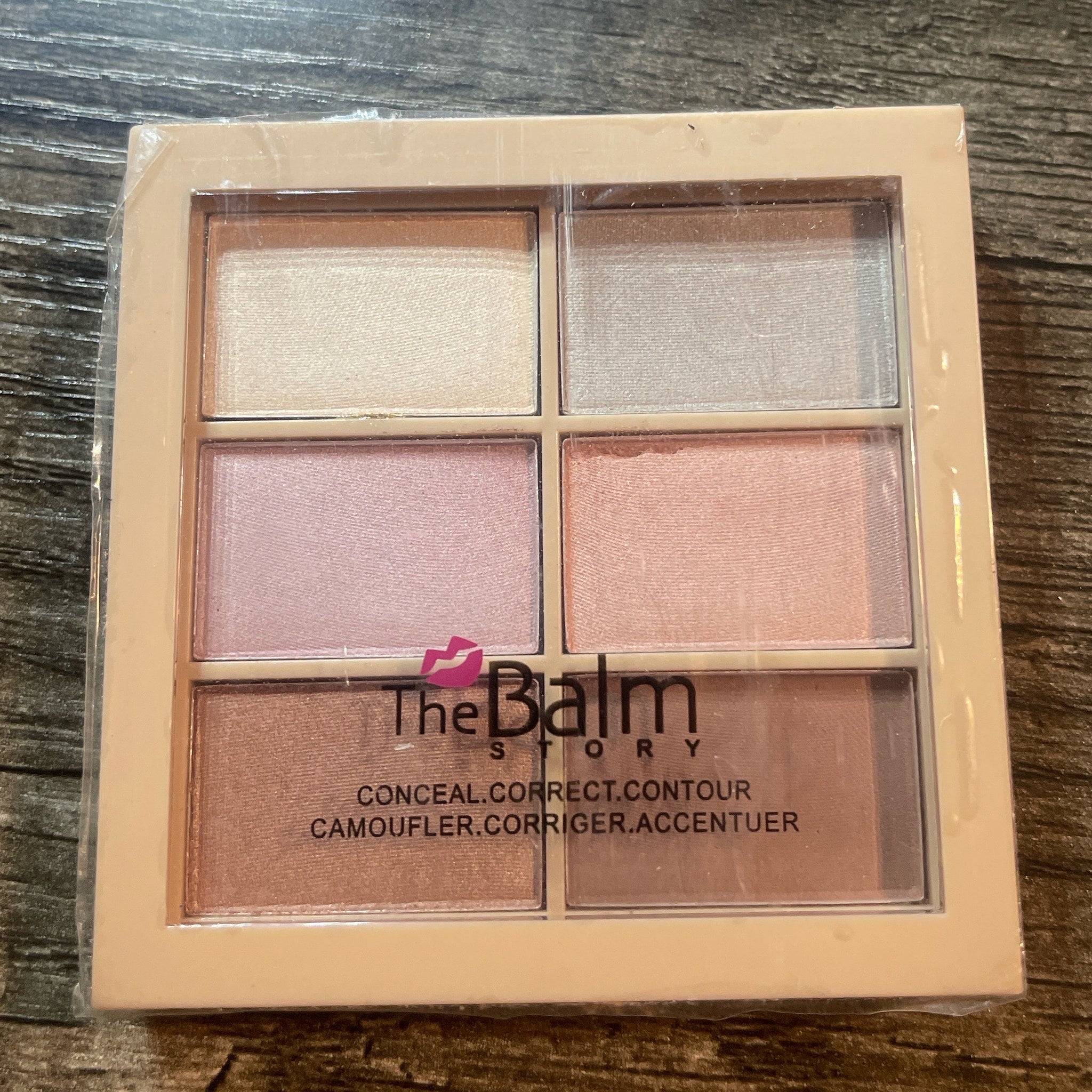The Balm Story face palette with pink, beige, and brown shades in a plastic case