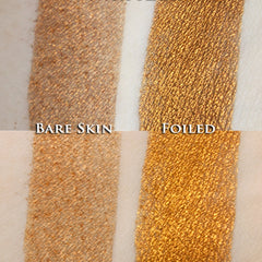 Hand applying metallic orange gold loose powder eyeshadow with a brush for a shimmery steampunk look