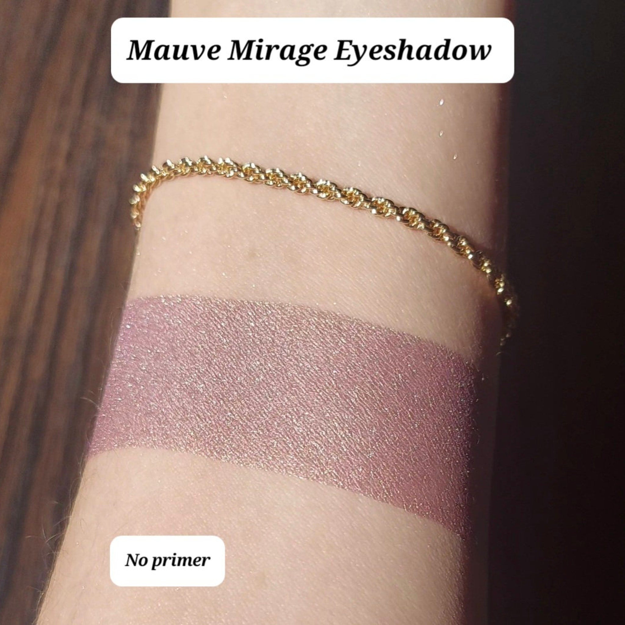 Close-up of vegan mauve eyeshadow with pink gold duochrome and bronze shimmer in compact pan