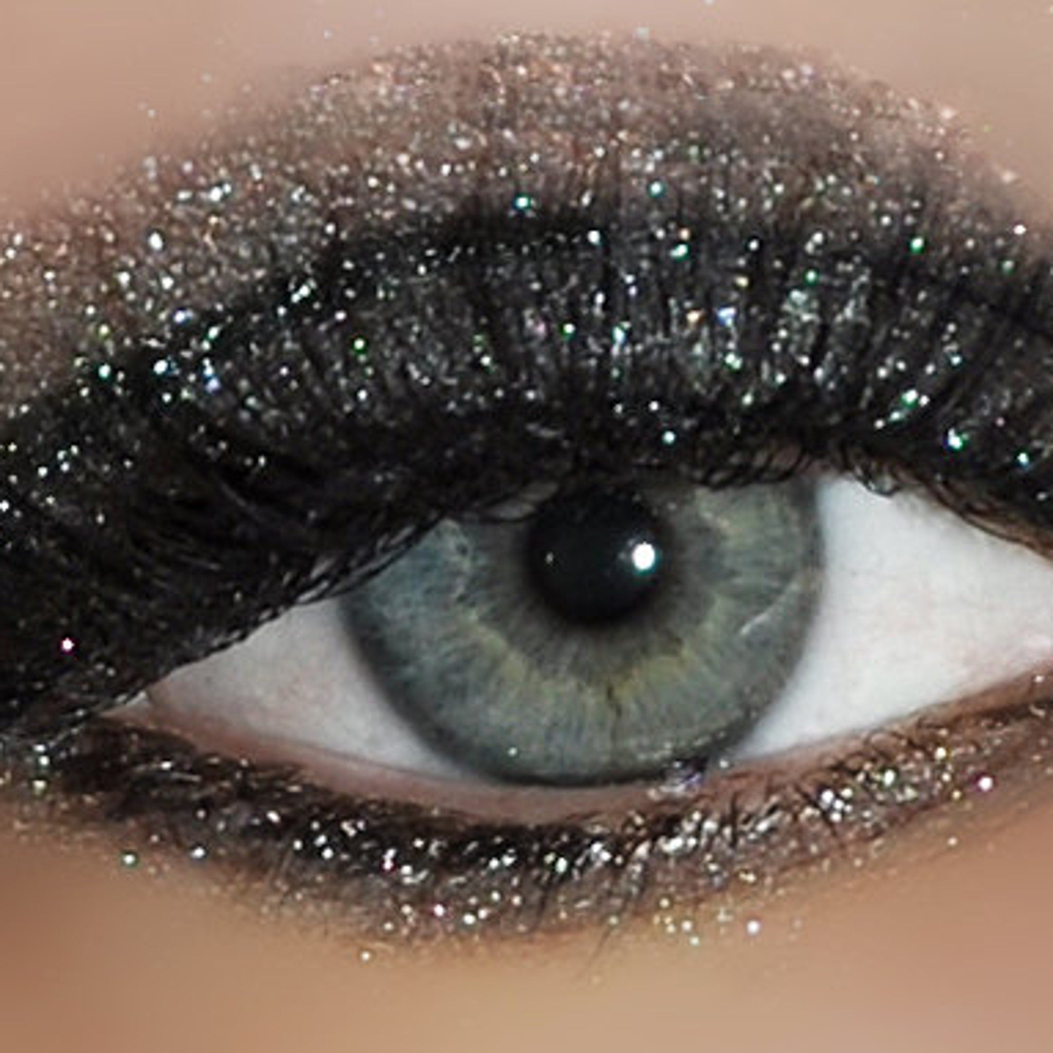 Side view of Dollipop Eye Shadow Sampler Pack displaying six vibrant powder shades in round pans with glossy black packaging