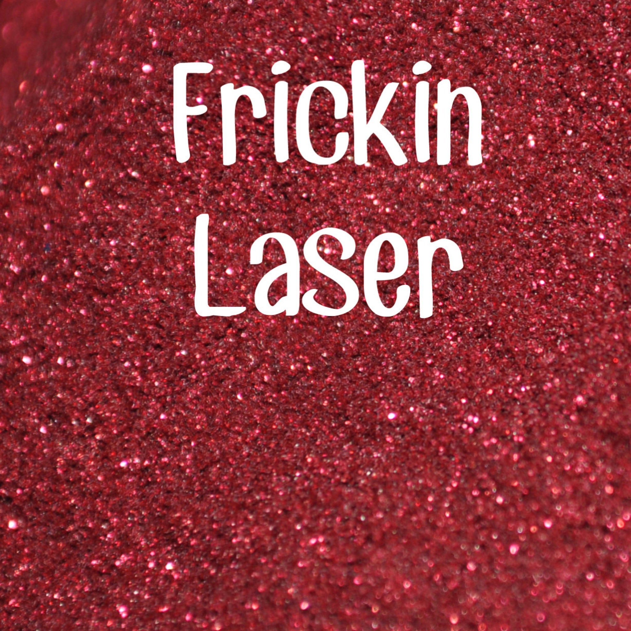 Small glass jar with black sifter lid containing vibrant laser-cut glitter eyeshadow in assorted colors
