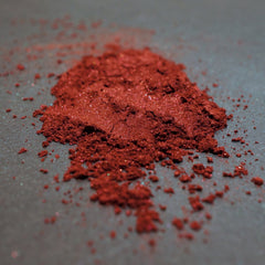Blood red metallic loose mineral eyeshadow in a small black sifter jar with gold label